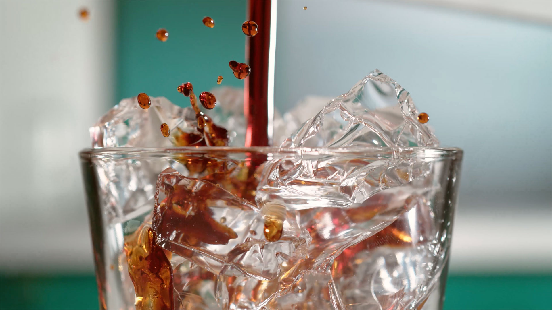 Coffee pouring on top of ice in a glass
