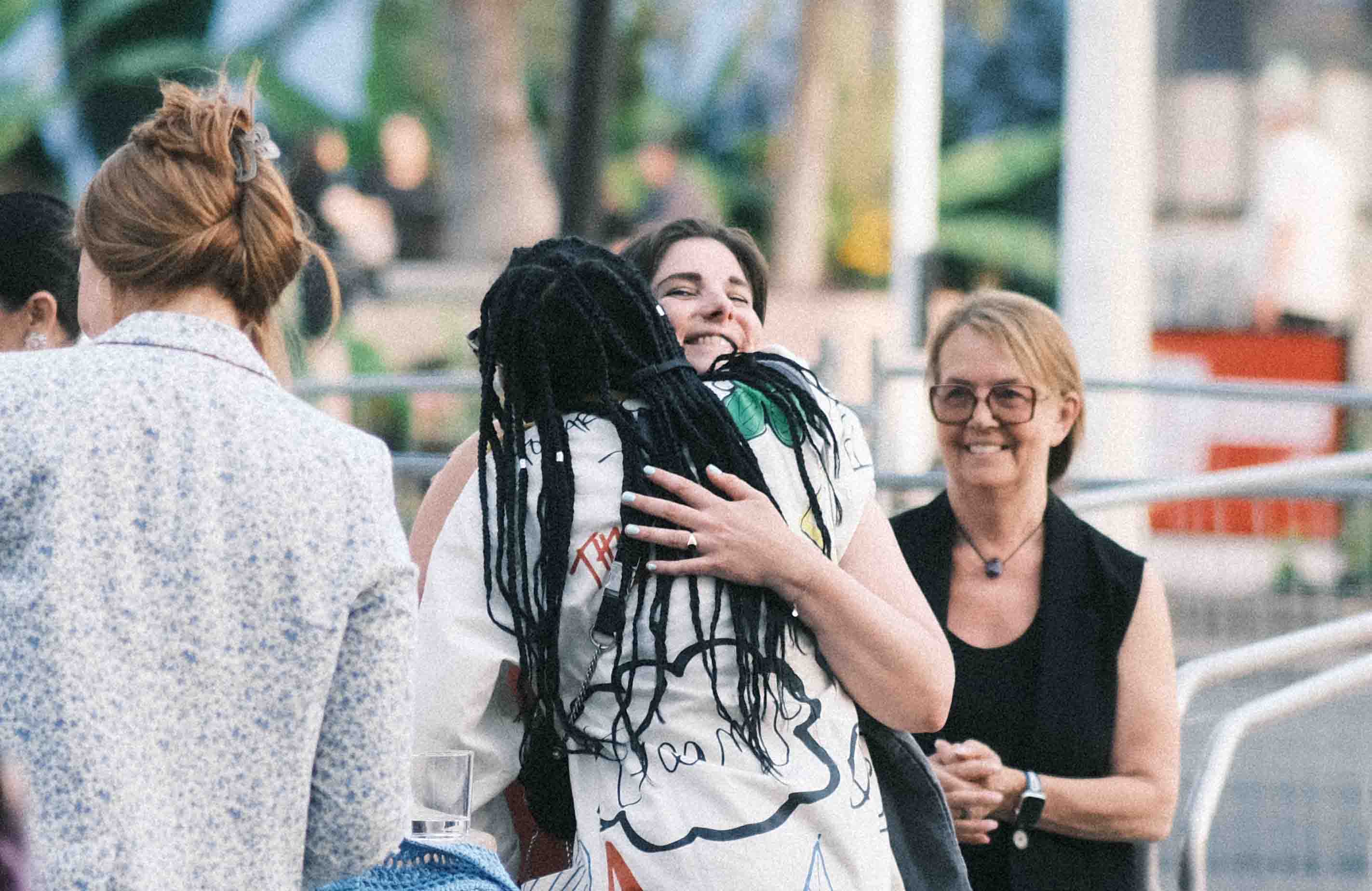 An employee hugging another employee at Cannes