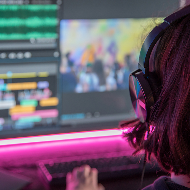 An employee editing a video on a desktop