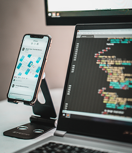A cellphone and a laptop showing code