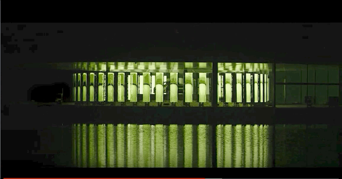 An exhibit flashes a yellow light up and down the structure