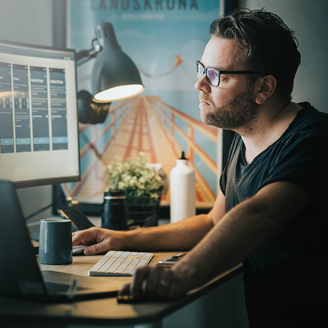 An employee working at their home desk
