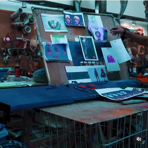 Someone working on computers and production equipment