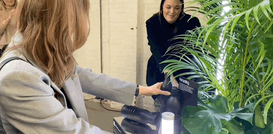 A person shining light on a plant