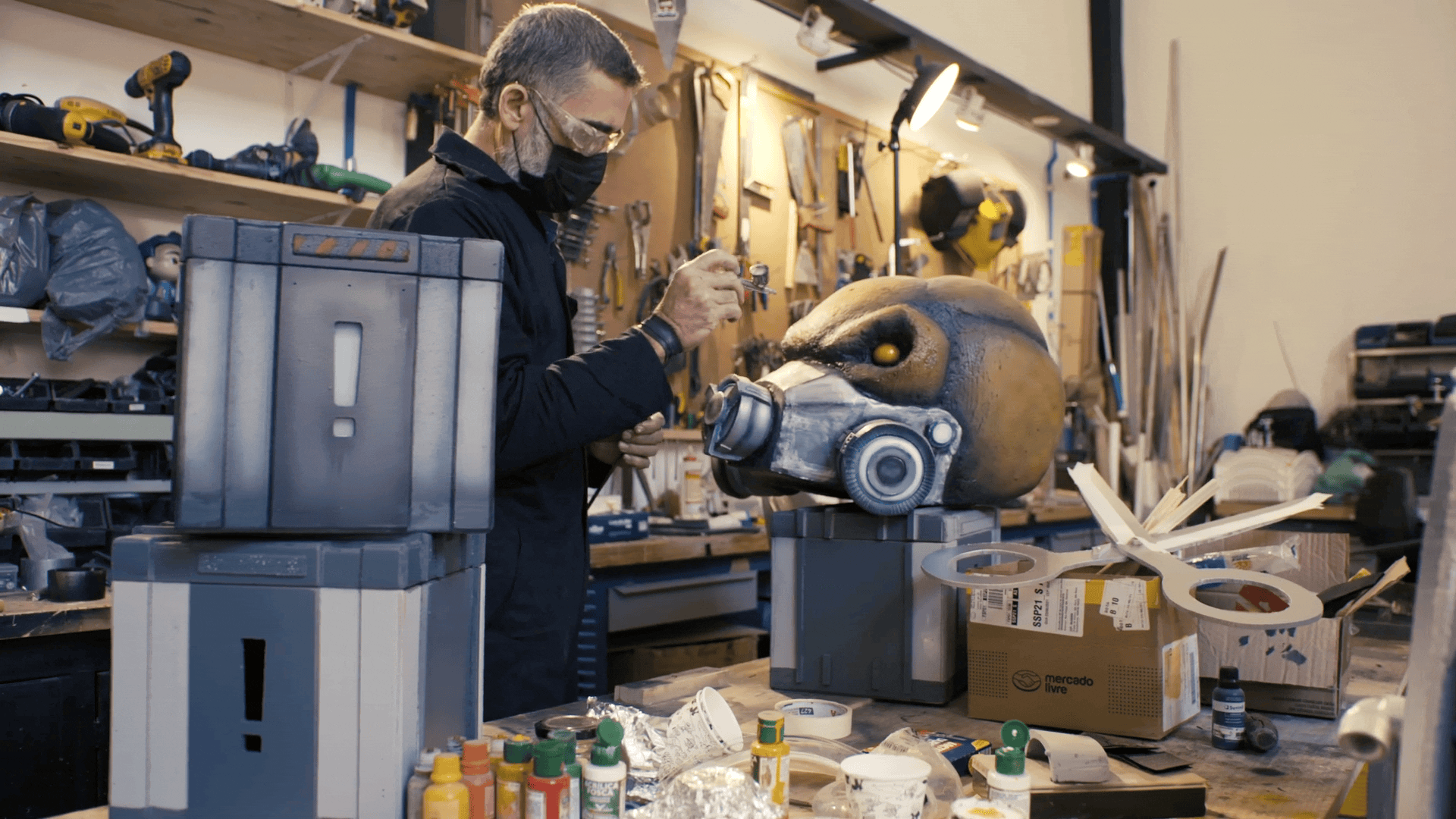 A person working in a workshop on a sculpture