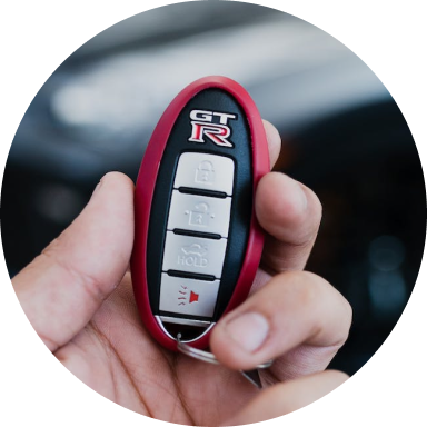 Hand holding a Nissan key