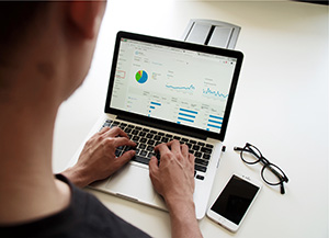 A person using google analytics on a laptop
