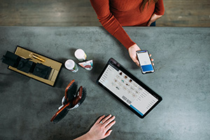 A person checking out using a tablet at a fashion store
