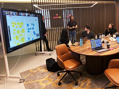 Media.Monks employees in a conference room looking at a smartboard