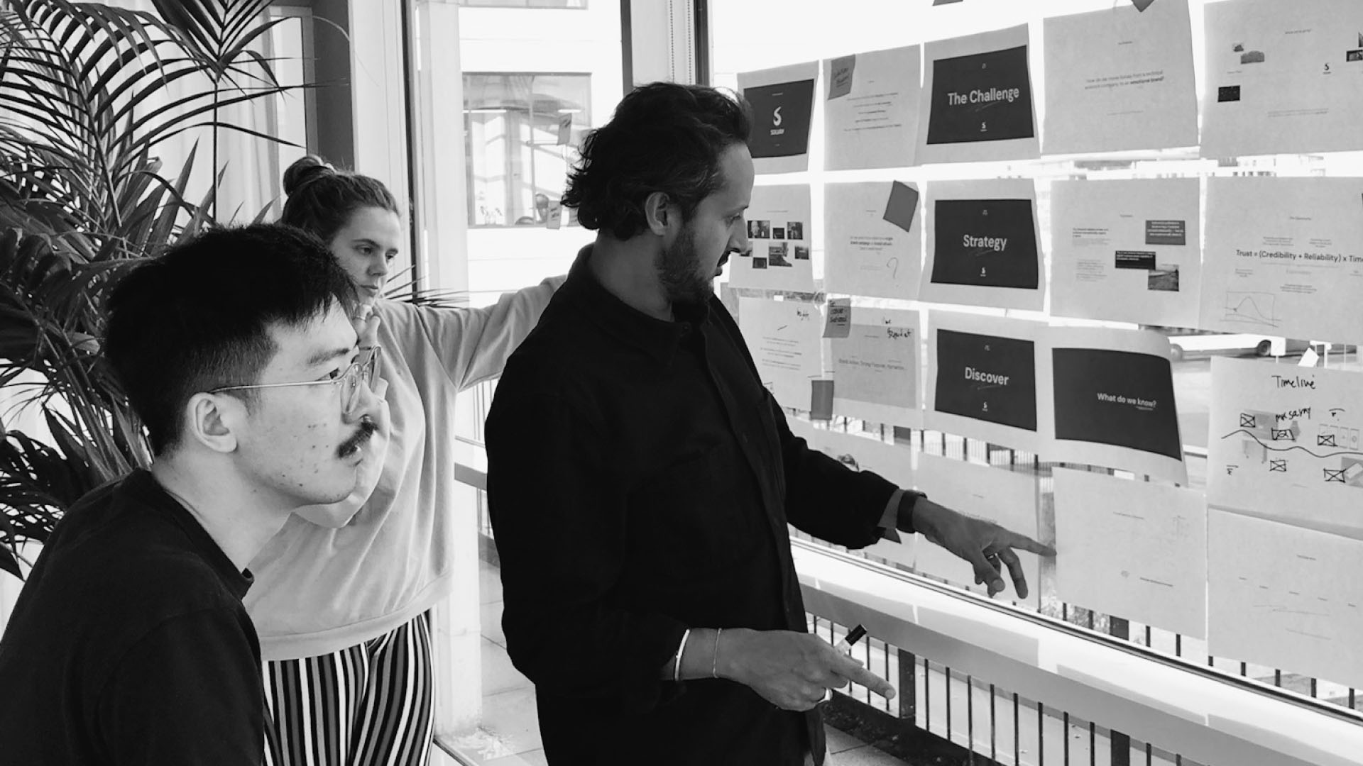 Brand.Monks working together and looking at concepts on a whiteboard