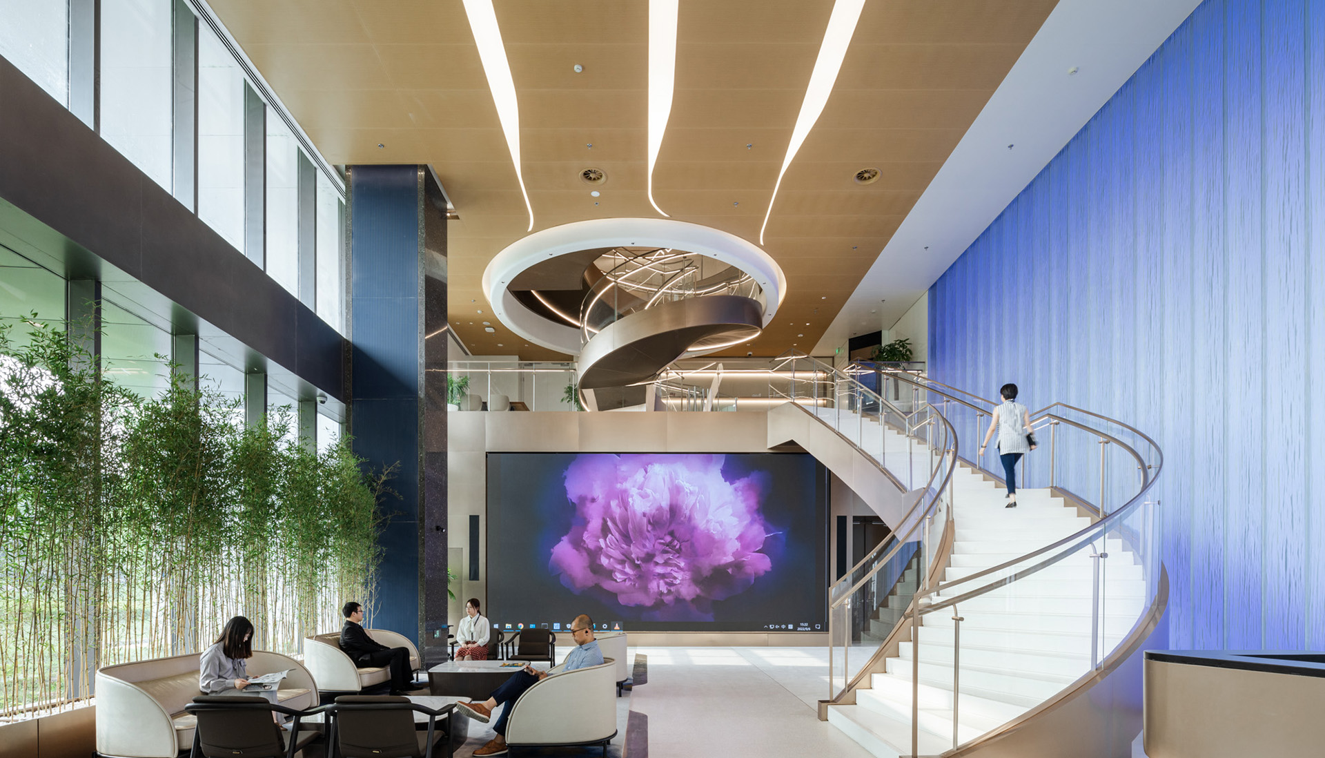 A large room with a monitor showing a big pink flower