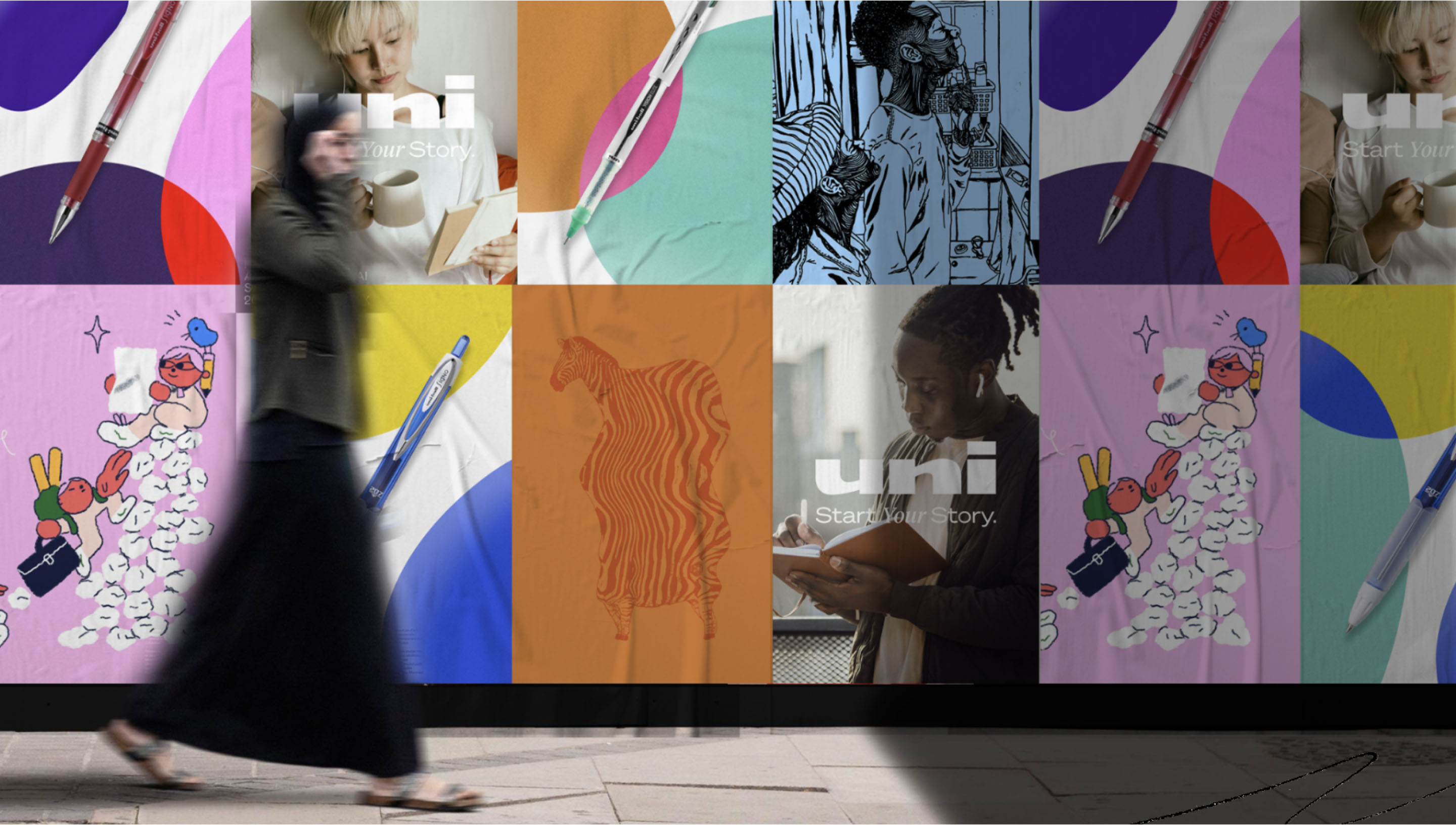 A wall with uni ads covering it while a person walks past