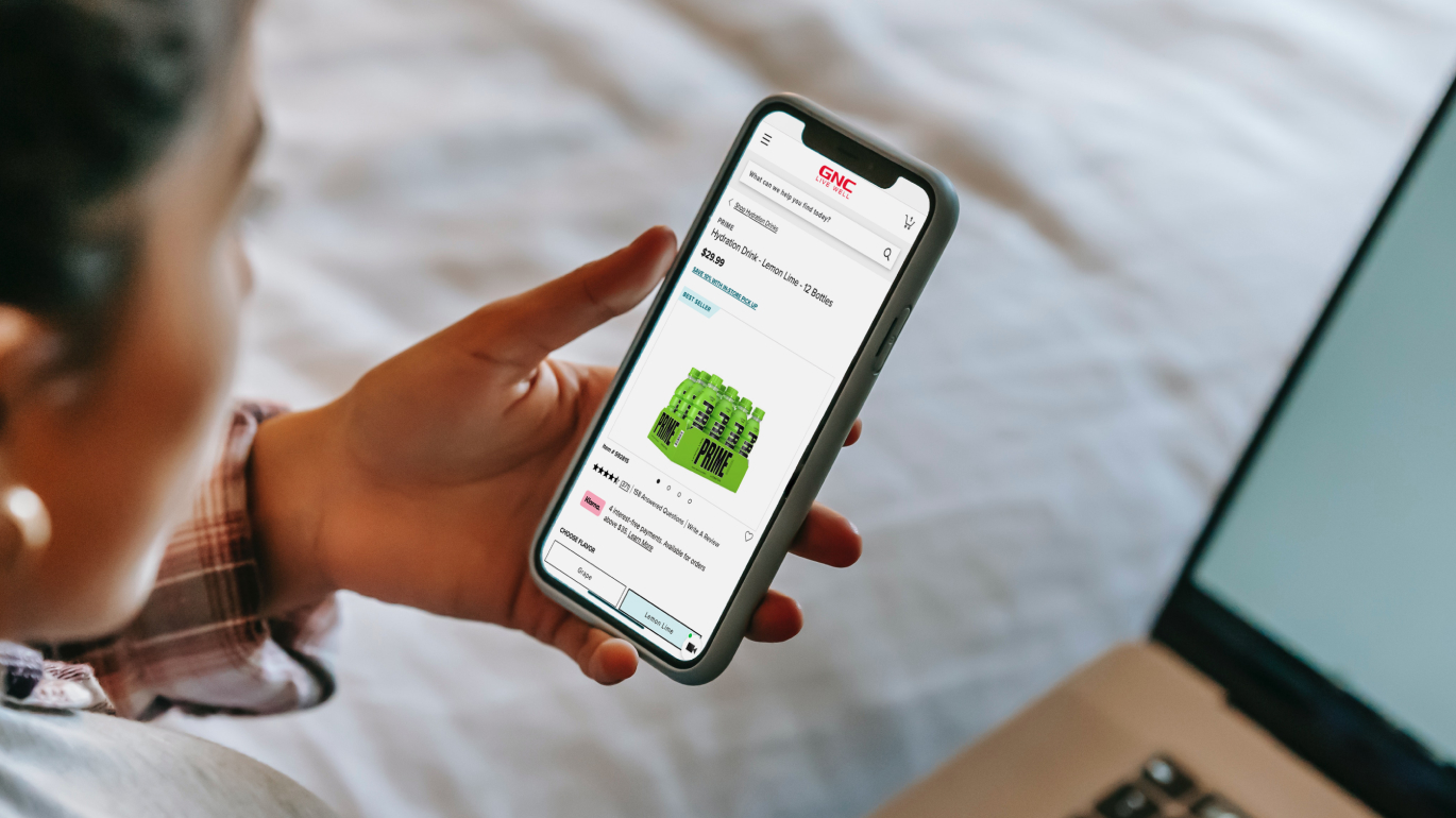 Person seen from behind. The person is looking at his mobile and on screen you see 