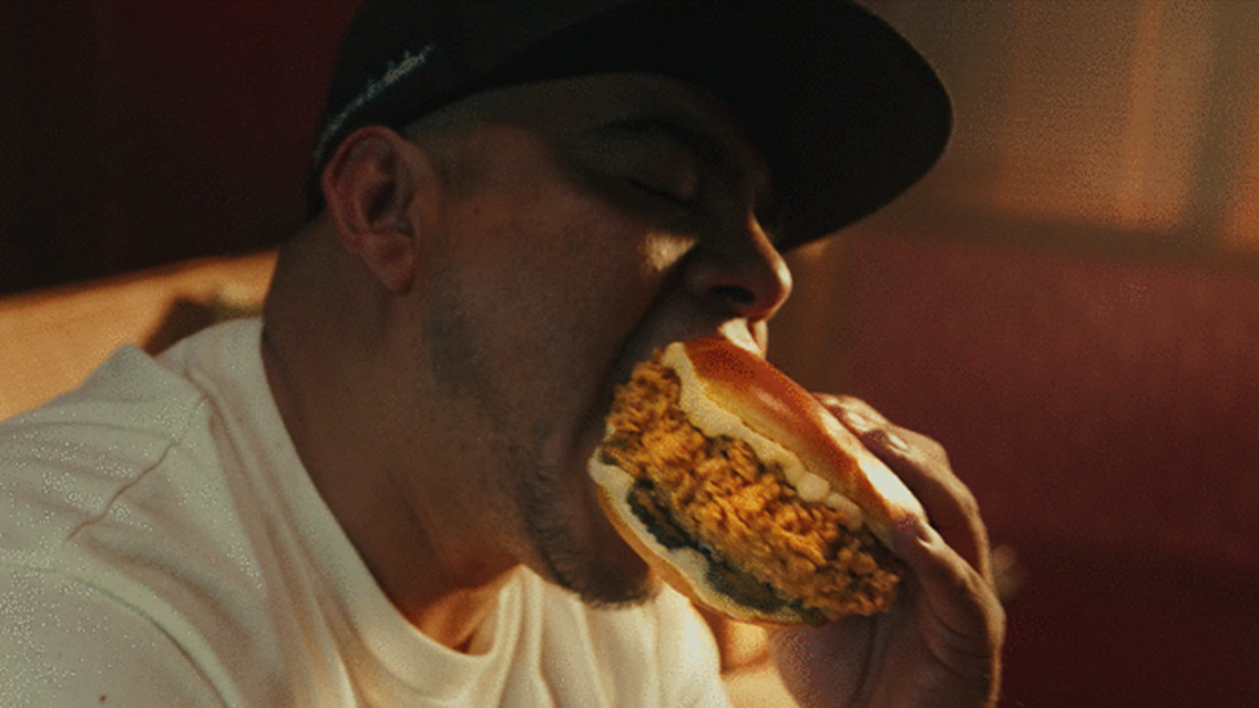 Mexico’s top freestyling artist ‘Aczino’ taking a bite of his KFC chicken sandwich