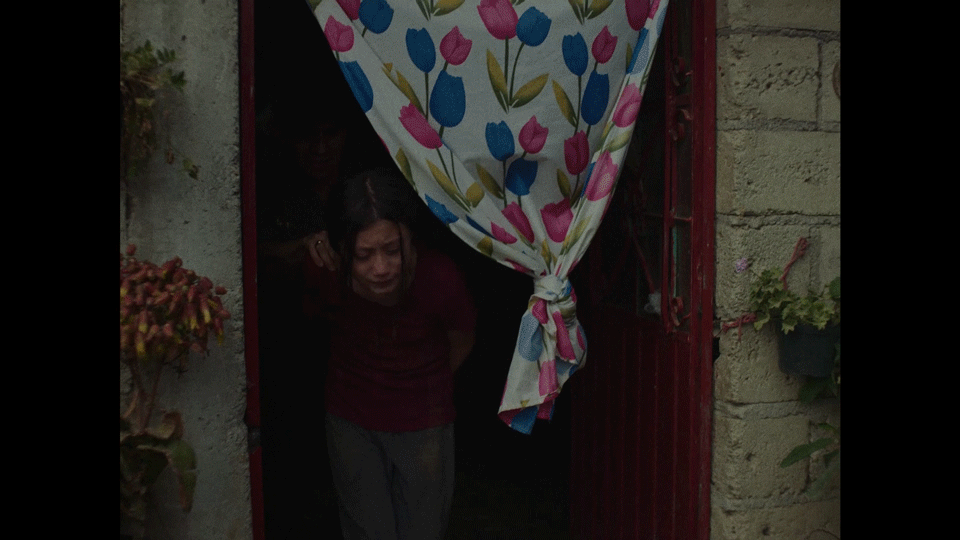 A policeman is escorting the girl out of the house where she was hiding