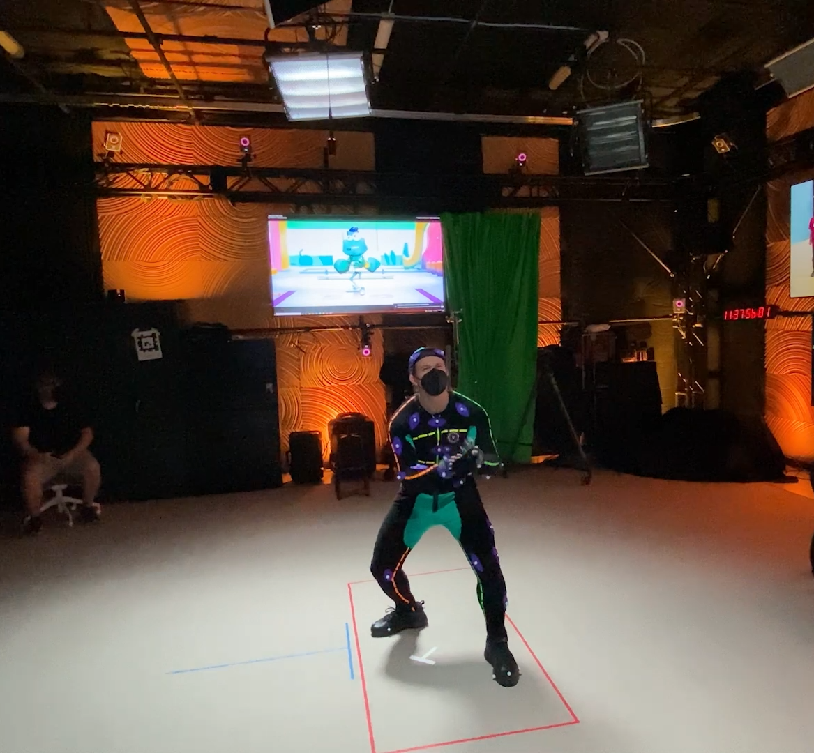 A person in a mocap suit on a soundstage