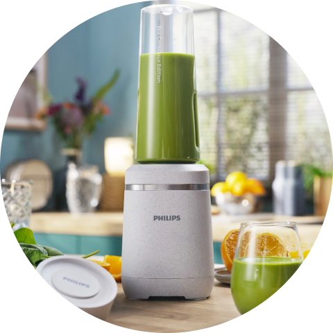 A Phillips blender with green juice in it