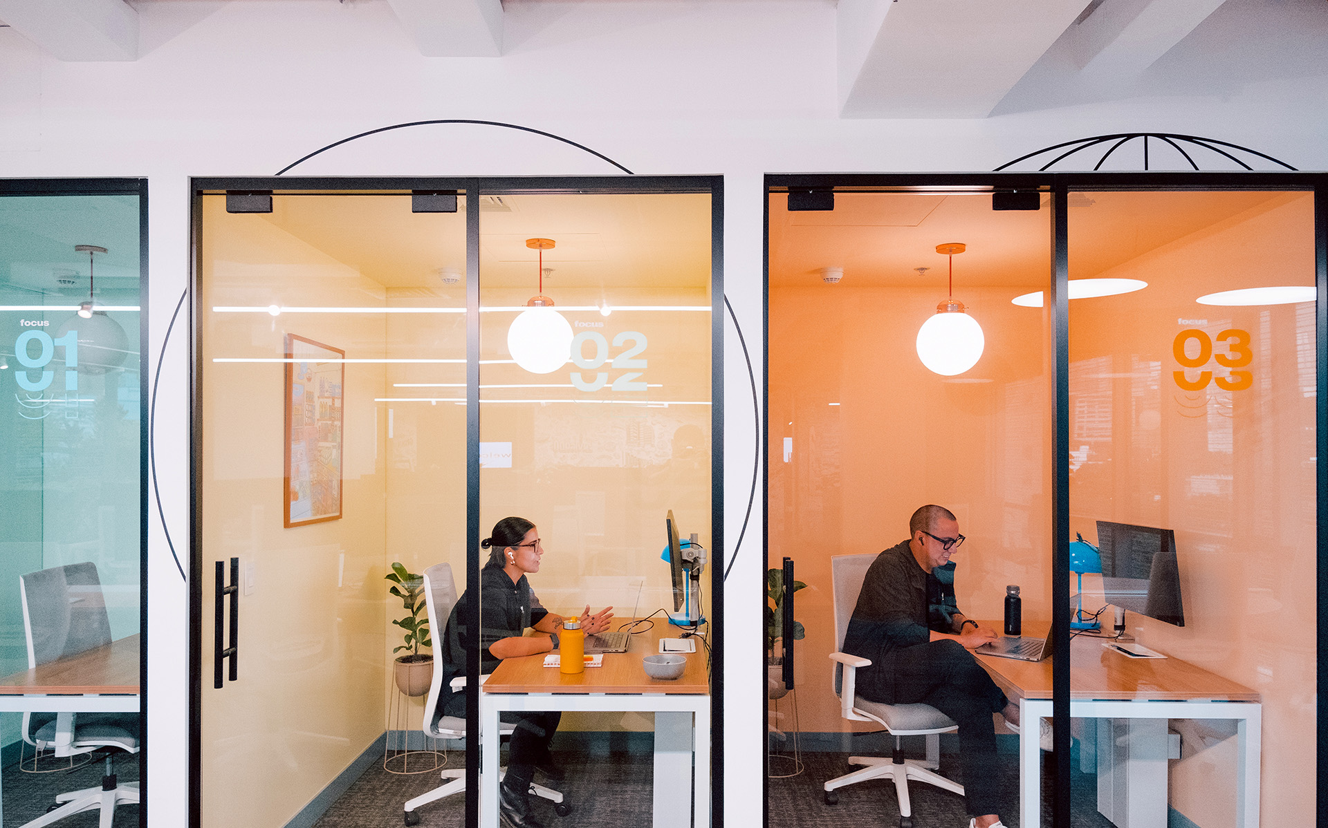Employees working in small meeting rooms
