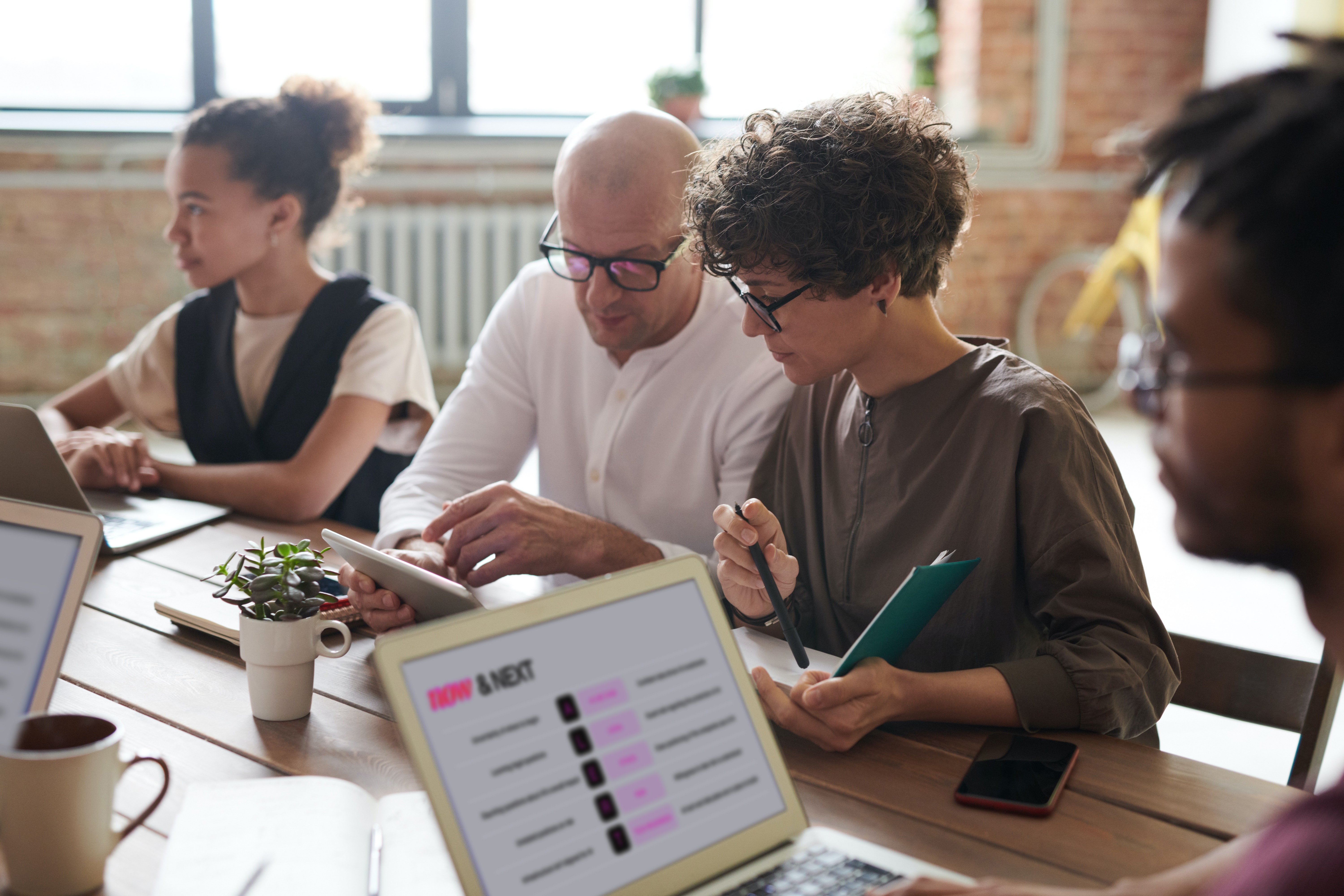 Employees around a table consulting with each other
