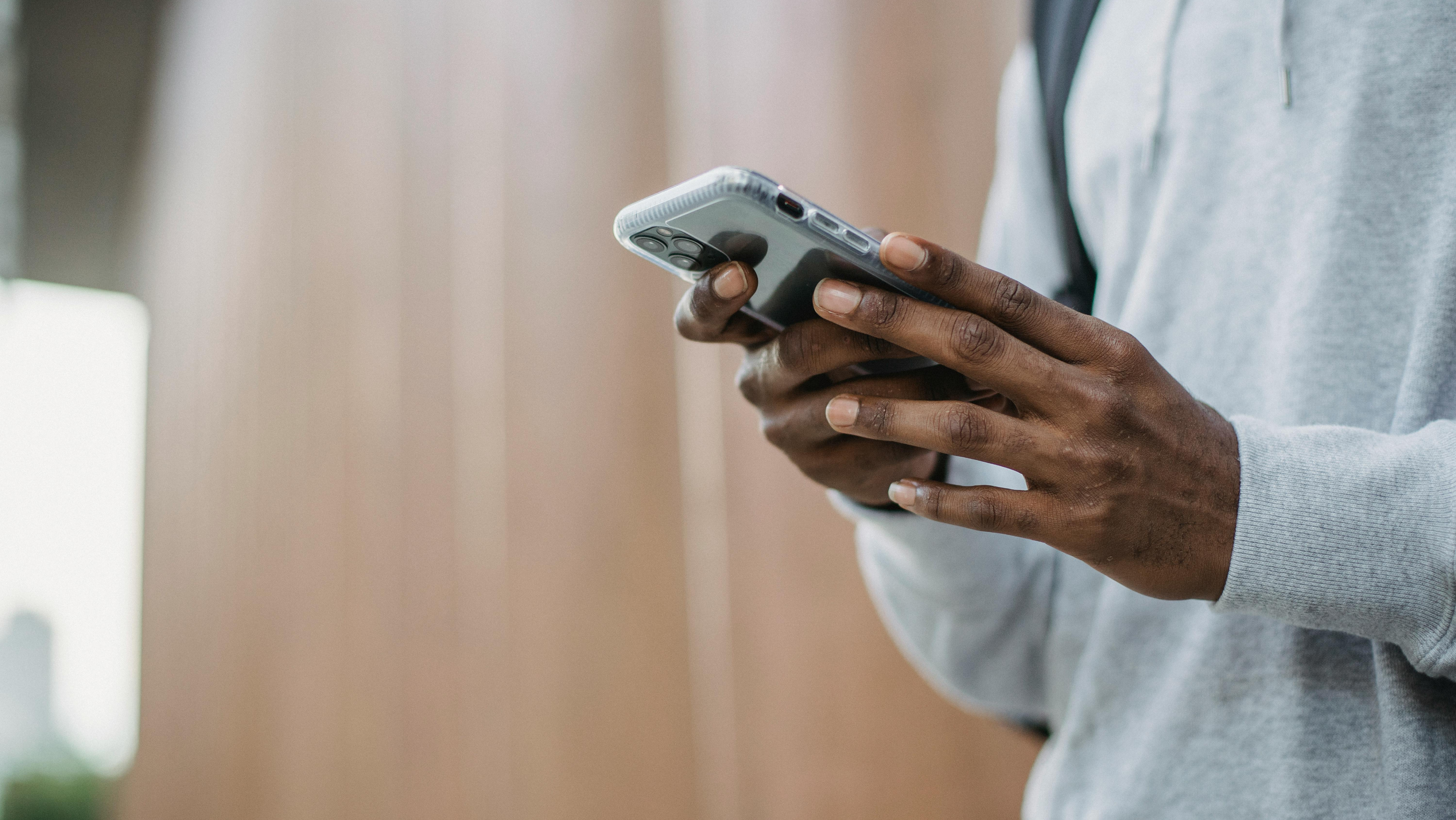 Person holding a cell phone in an office environment