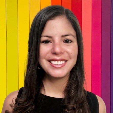 Maria Reinoso from Headspace, in front of a colorful background