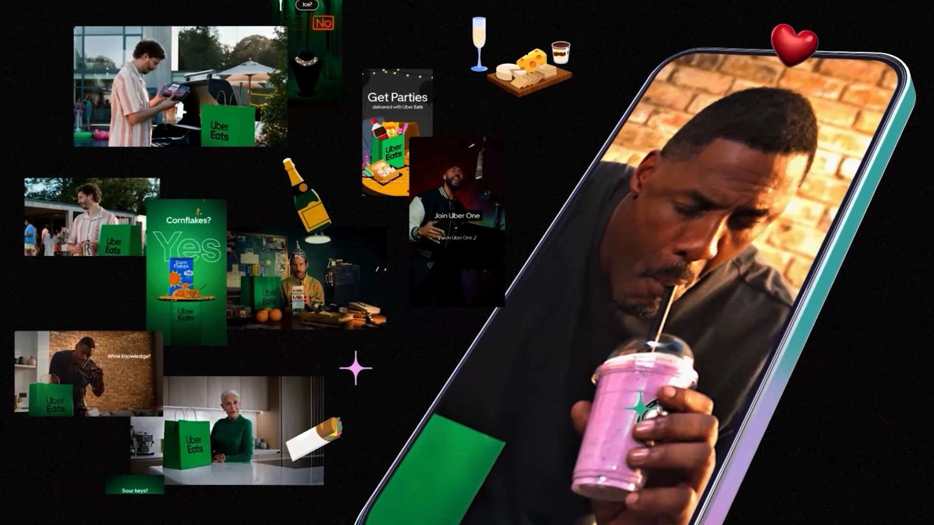 Idris Elba drinking a milk shake with a bunch of phone mock up designs surrounding him