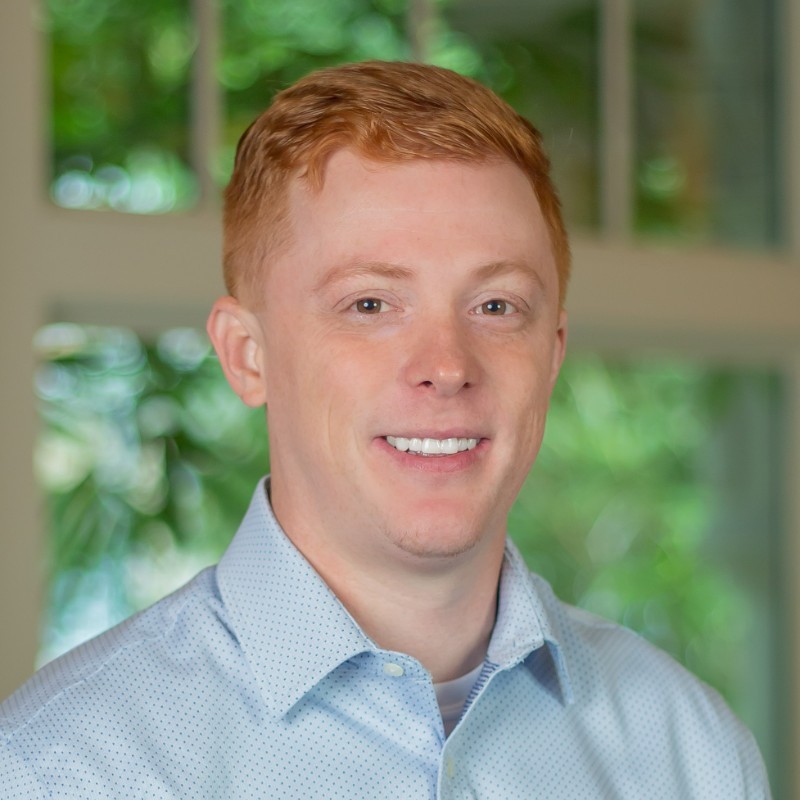 Nick Berta from Paycor, smiling at the camera in front of a window