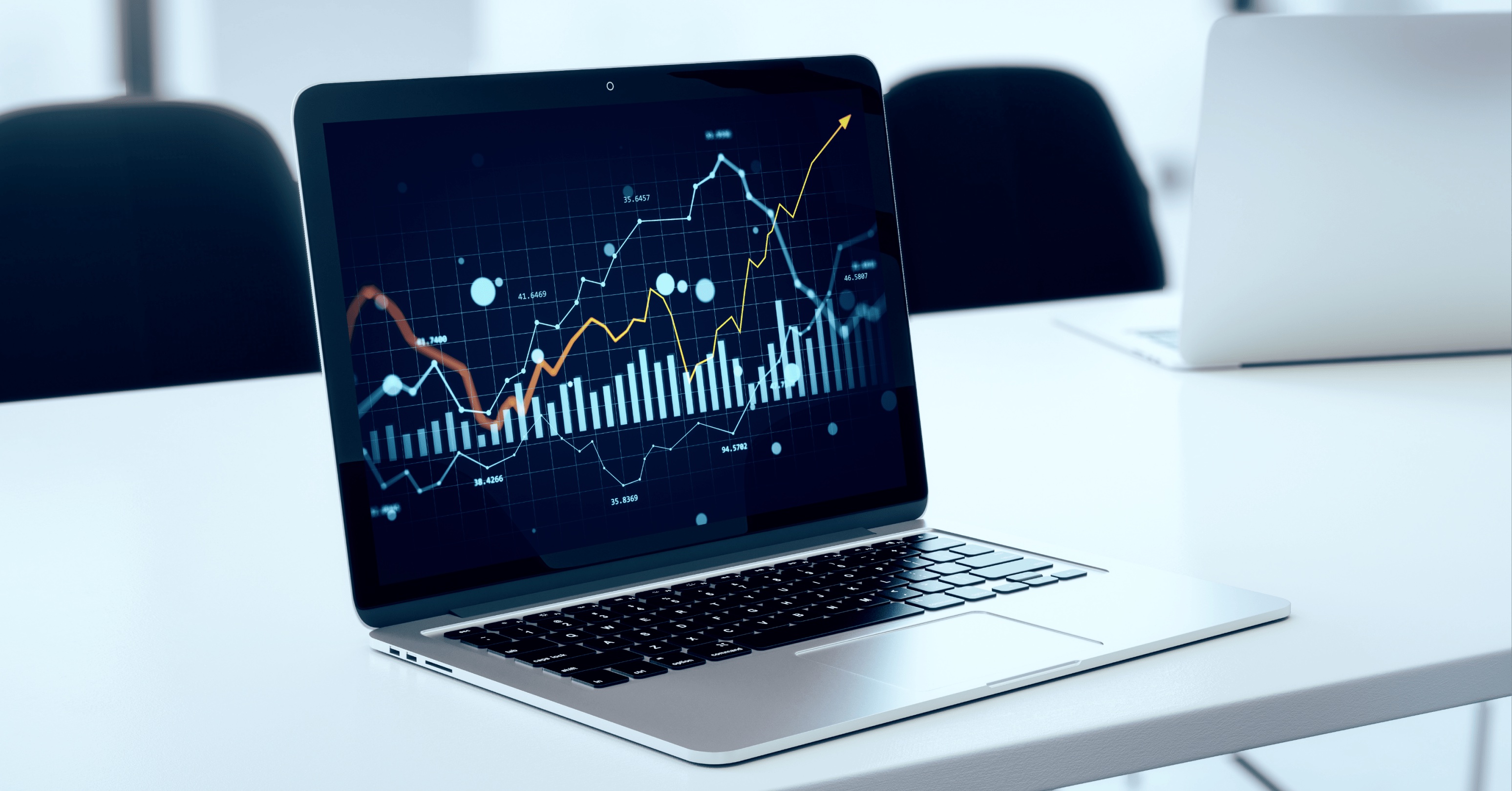 A laptop screen displaying a complex data dashboard with upward-trending charts, representing the measurement of SEO return on investment (ROI) and performance analytics.