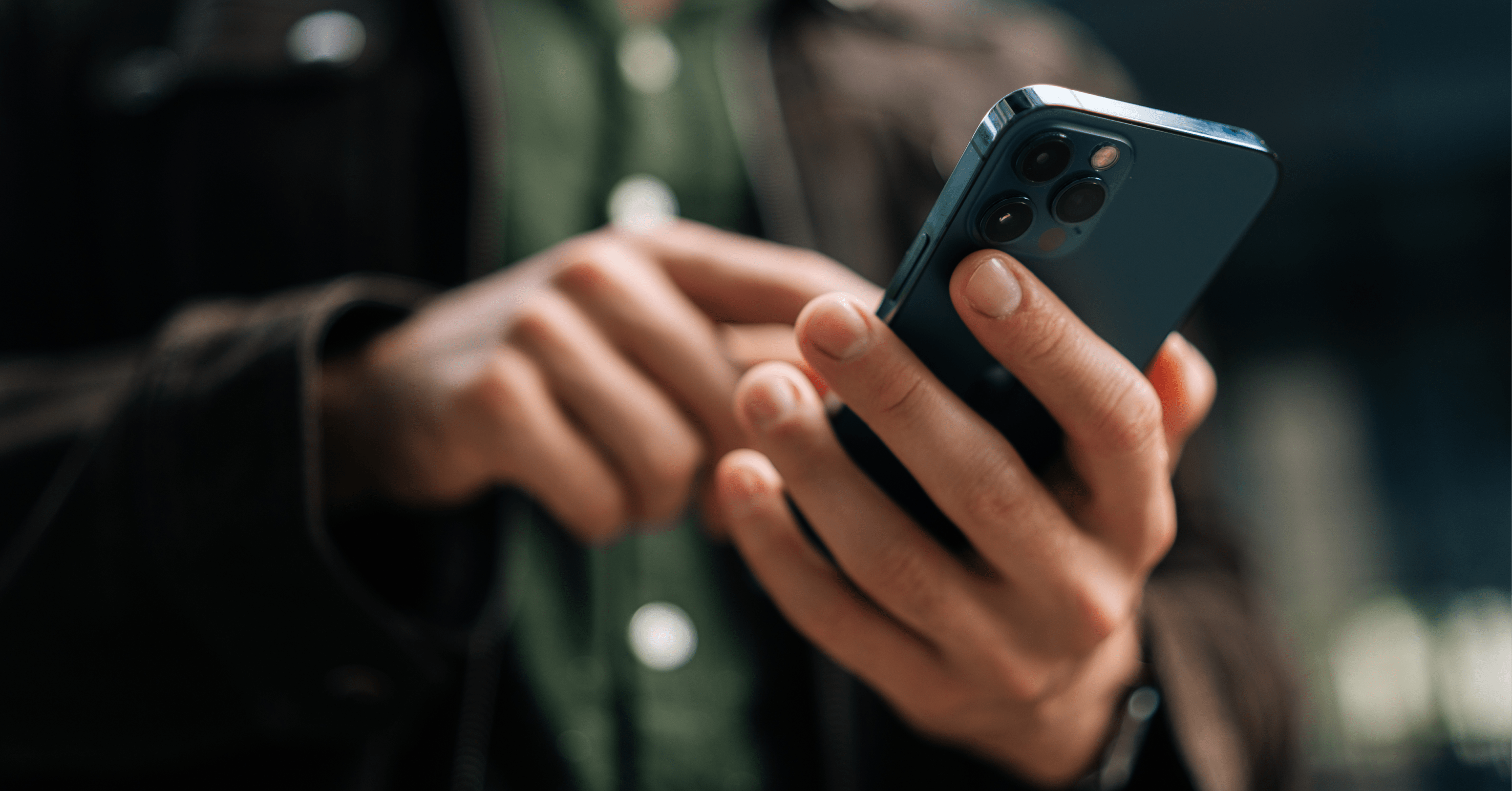 Close-up of a person using a dark smartphone for mobile search, illustrating the importance of a mobile-first SEO strategy and user experience.