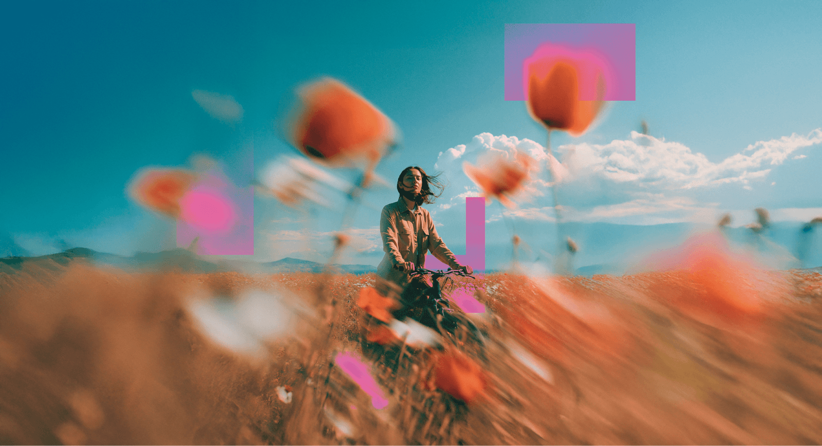 Girl standing in a flower field with a bicycle 
