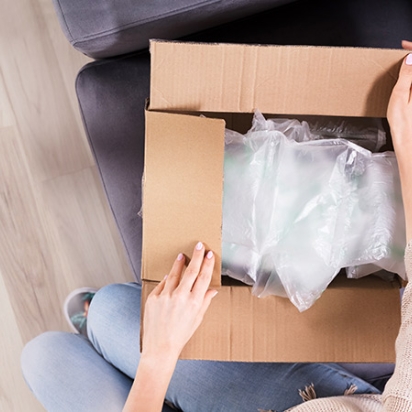 Woman's hands opening delivery box