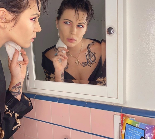 A person applying make up to their face in a mirror