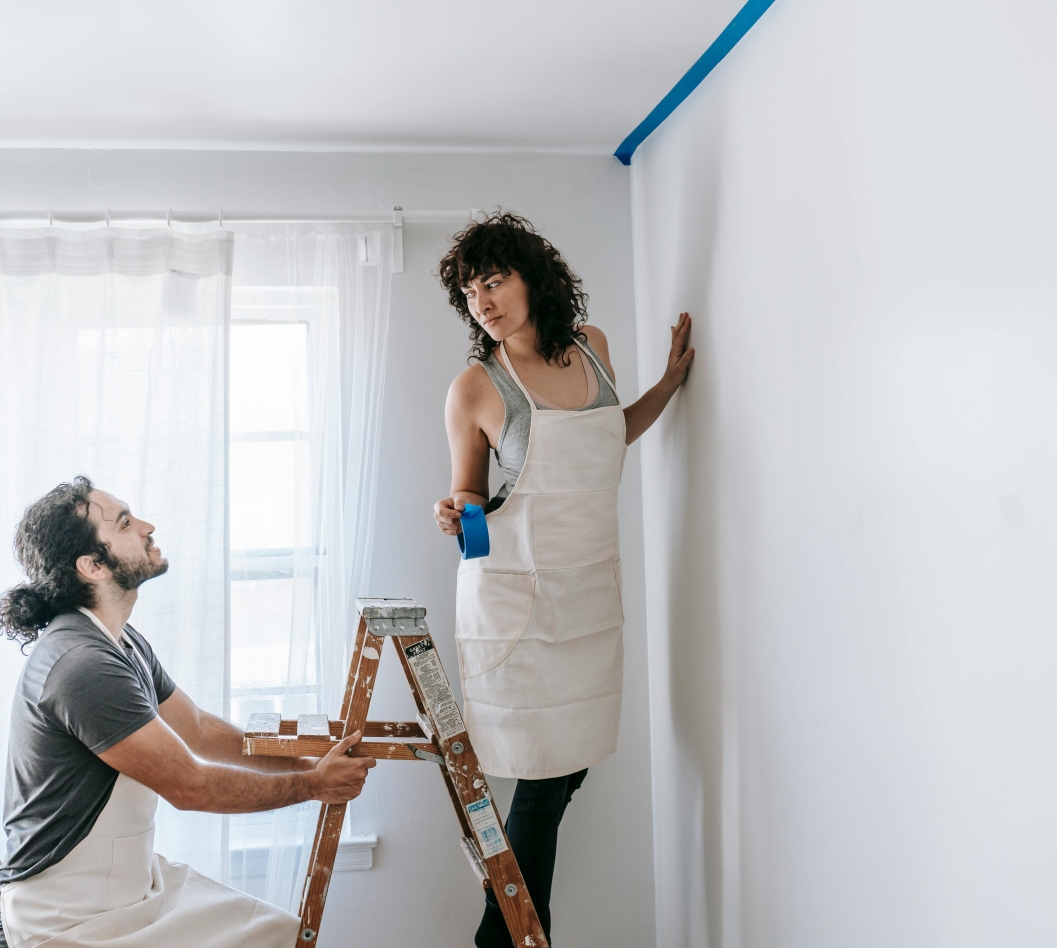 man and woman painting the wall