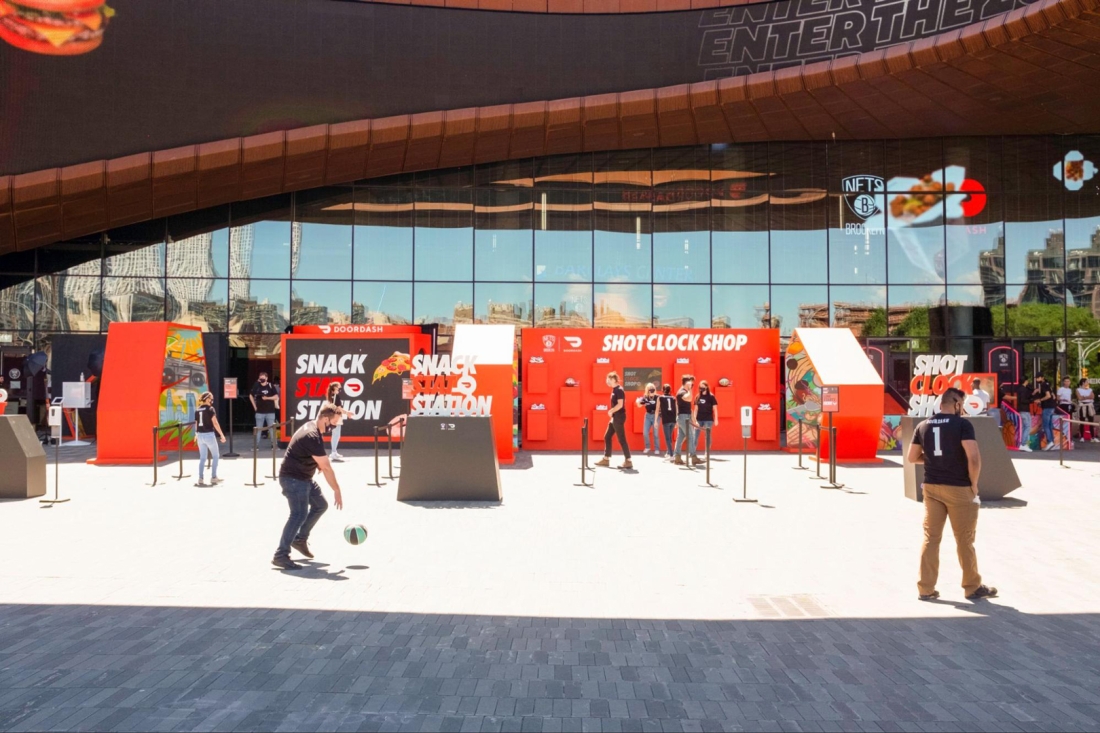 A large tunnel with people playing basketball around it