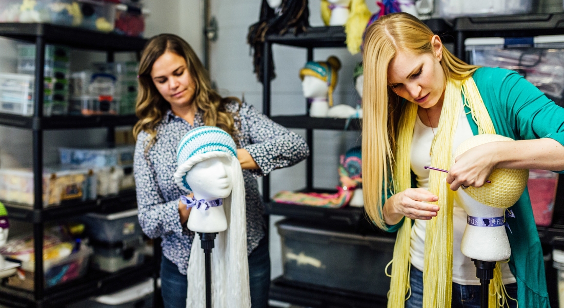 Two women making hats