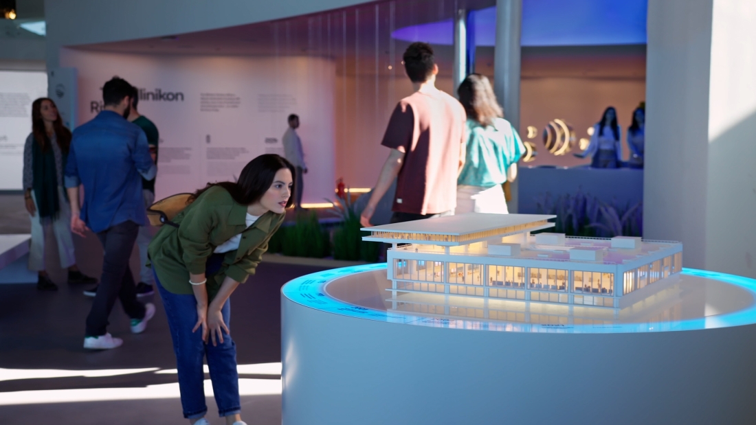 A person looking at a small scale diorama of the experience centre