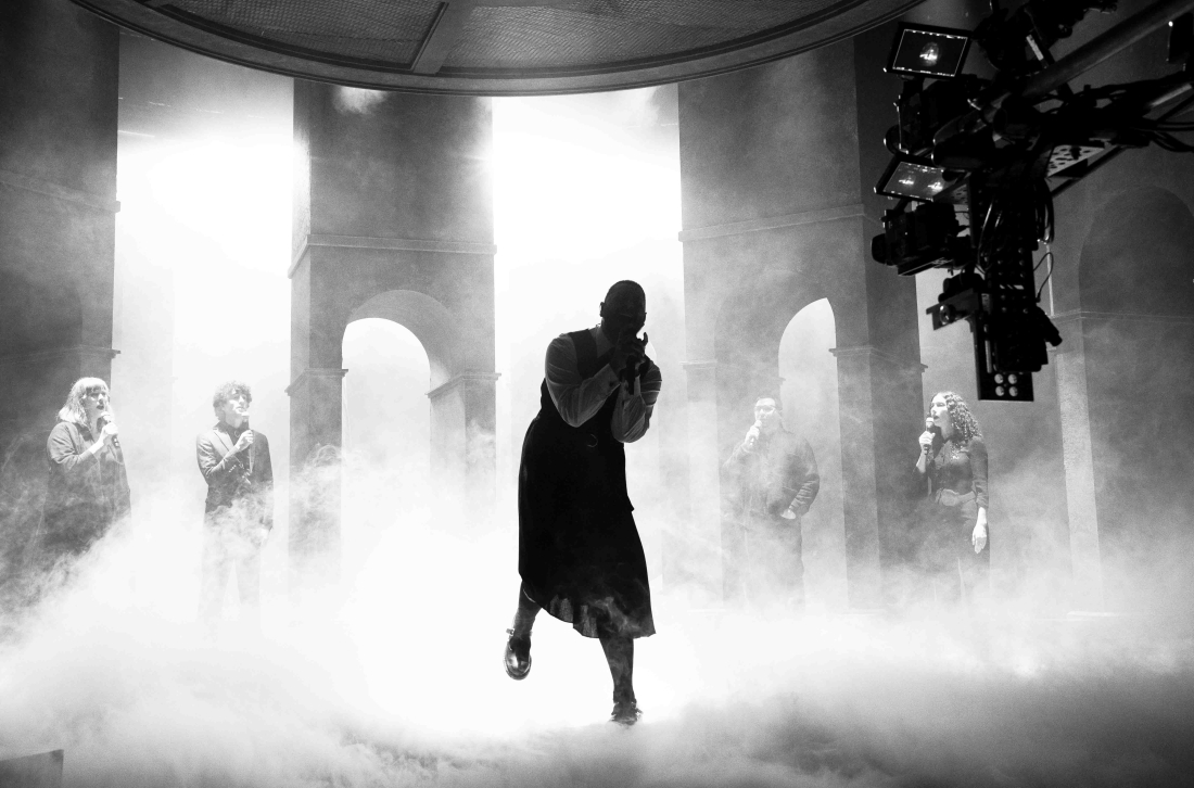 Post malone on a smokey stage