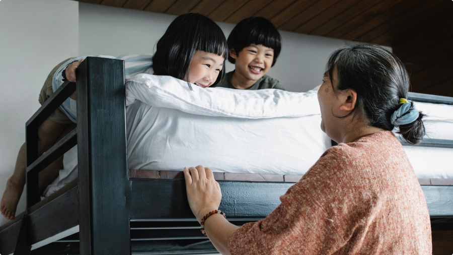 A mom talking to her children in bed