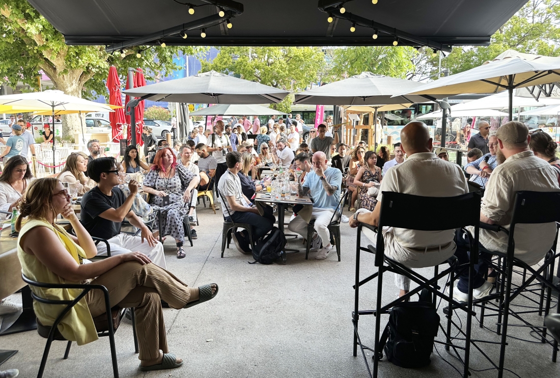 Les Monks Cafe with attendees listening to a panel talk