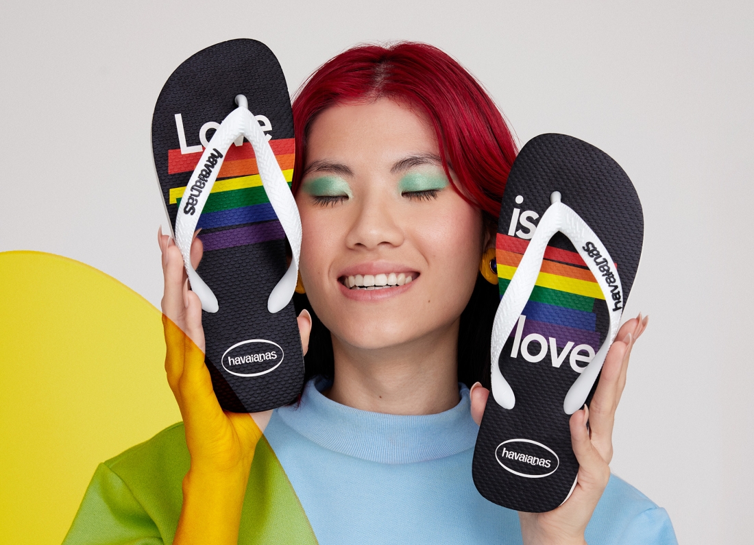A person holding havaianas flip flops in front of their face