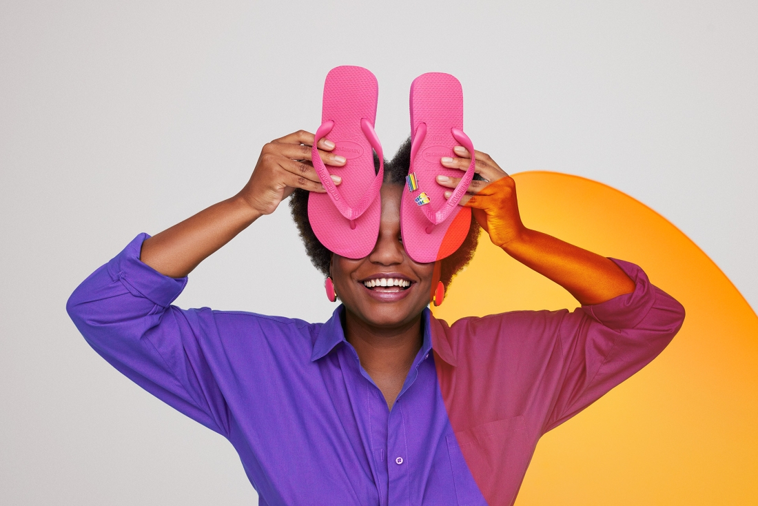A person holding havaianas flip flops in front of their face
