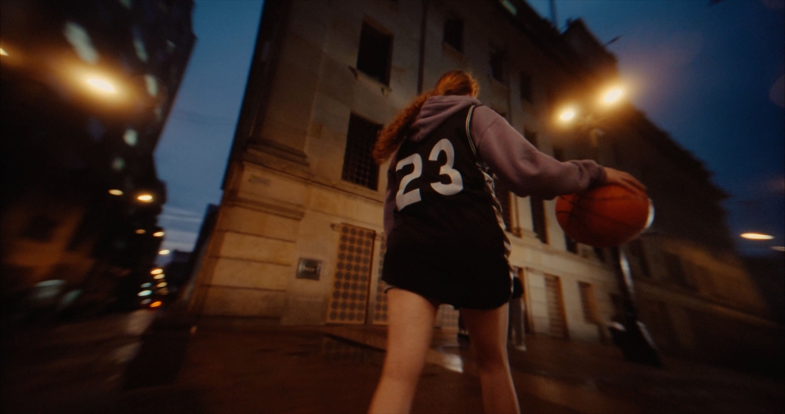 A girl dribbling a basketball