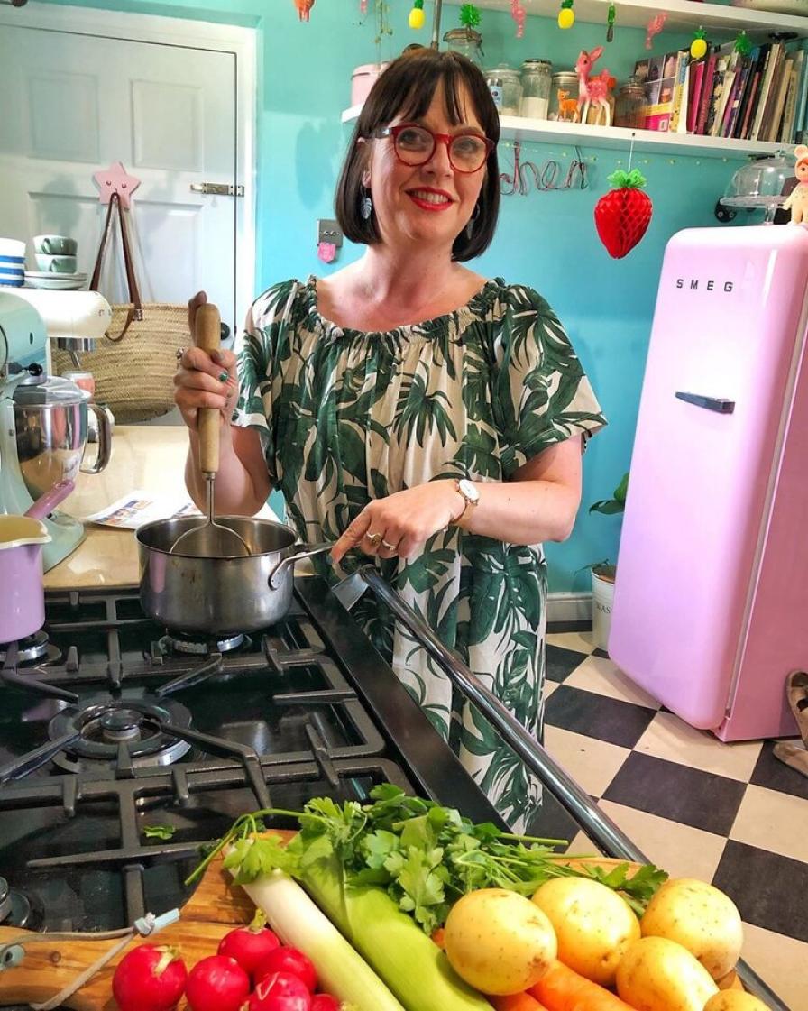 Woman in kitchen and pot