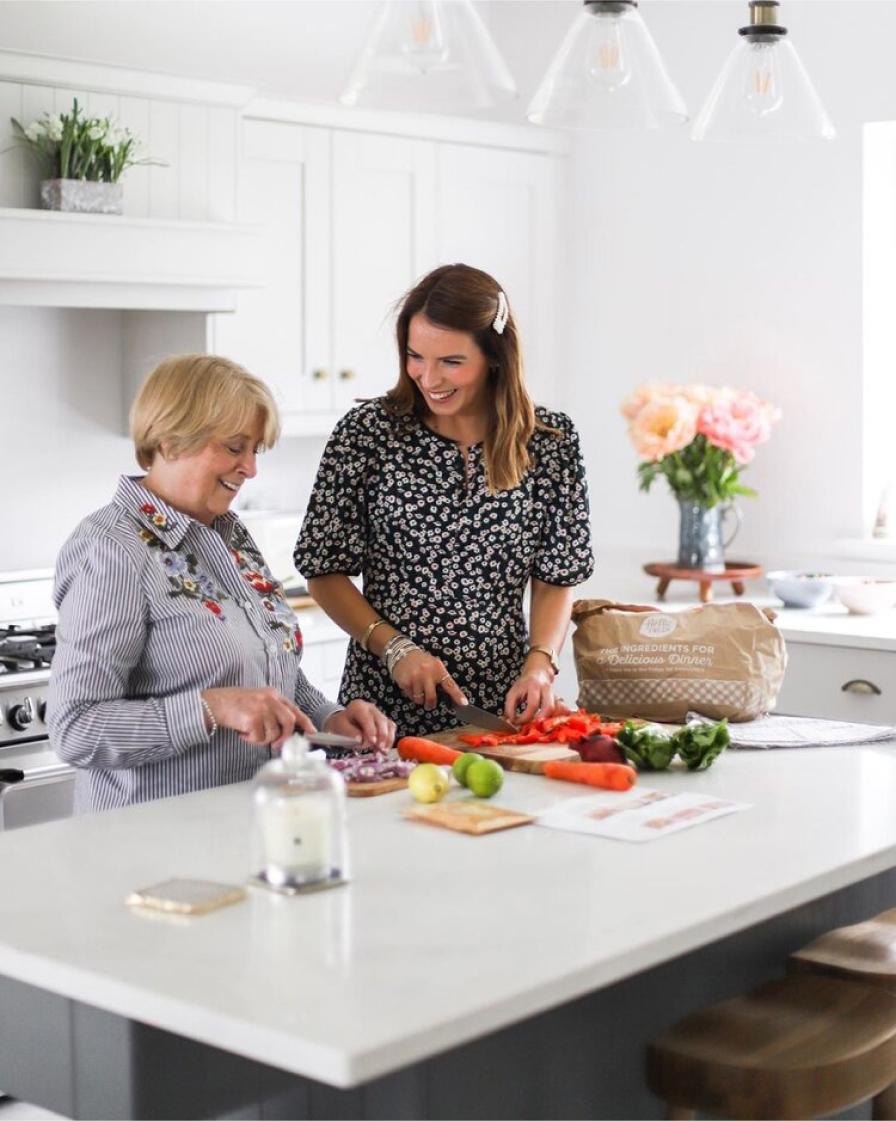 Two women cutting carrots