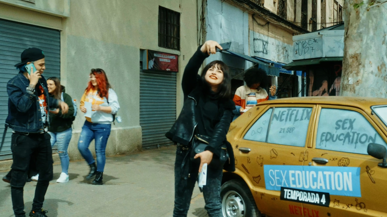A person taking a selfie in front of the yellow F***ing Car