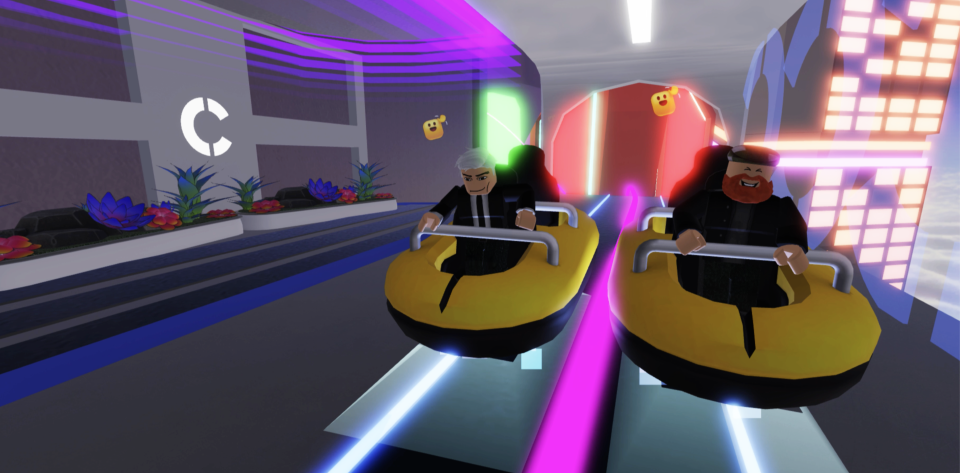 Two characters in Roblox ride a rollercoaster