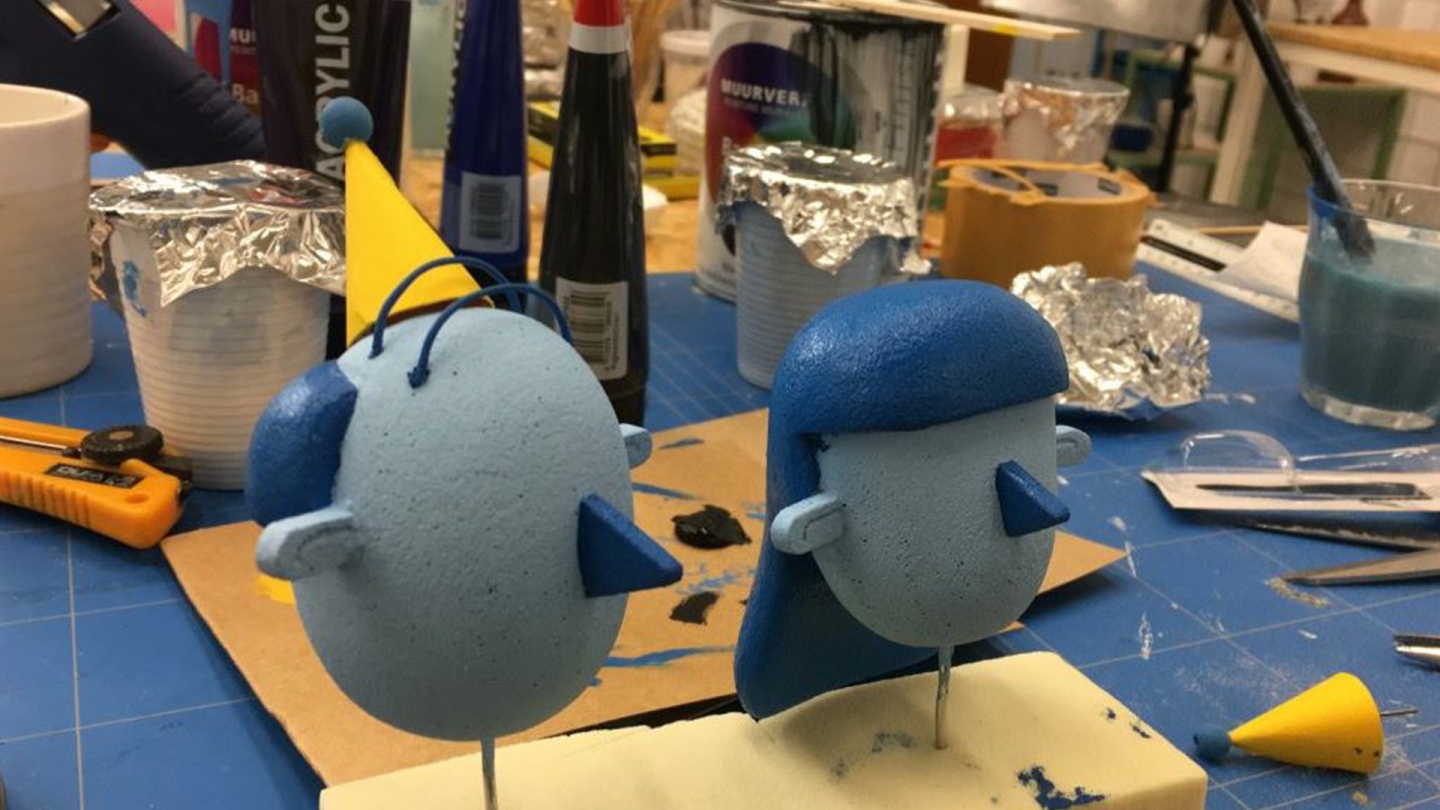 Overview of the creation of twee characters for the animation. Two blue circles with in darker blue noses and hair pasted on the faces.