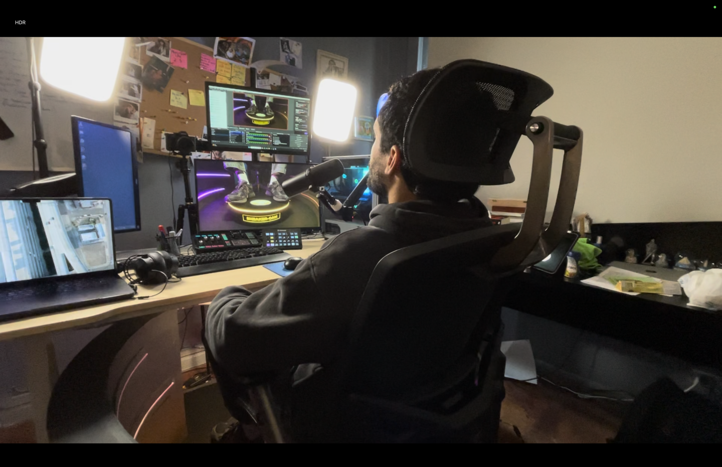 A streamer sitting at their desk with their new setup that includes the Sneaker Cam to show off their shoes to the viewers
