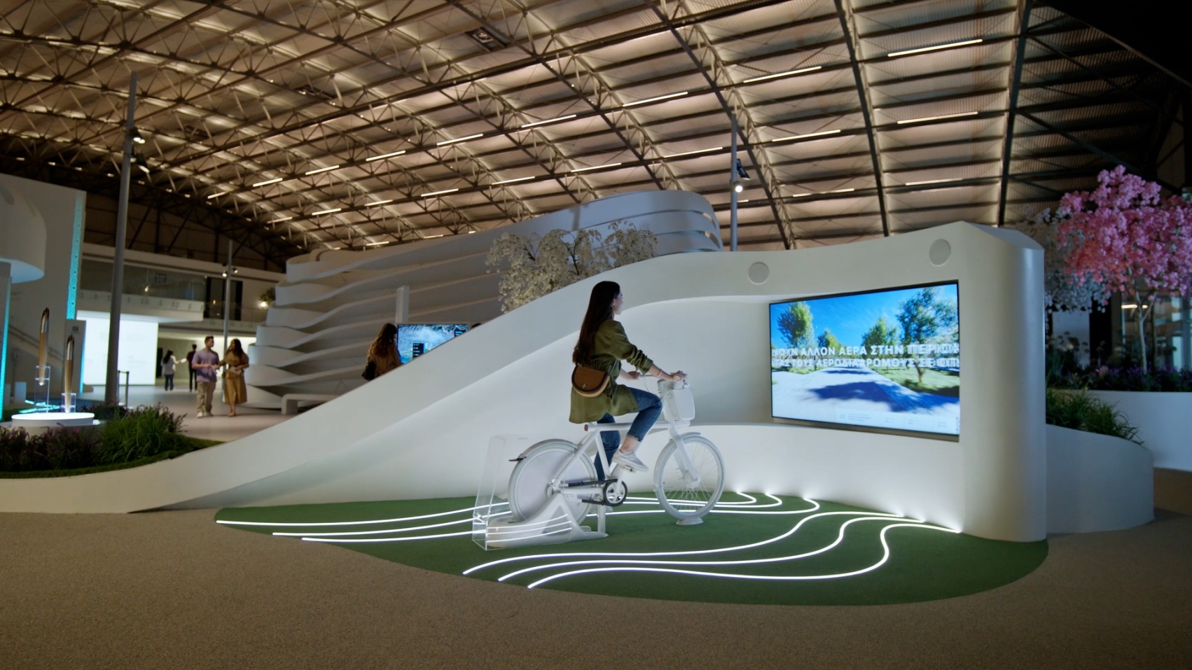 A person riding a bicycle that creates energy for an exhibit