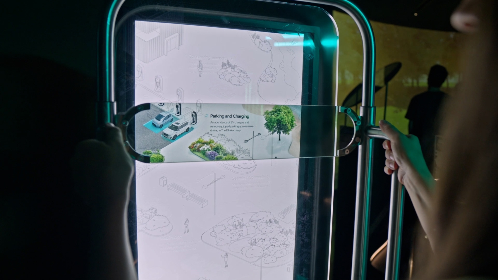 A screen shows a blueprint of cars charging in a parking lot